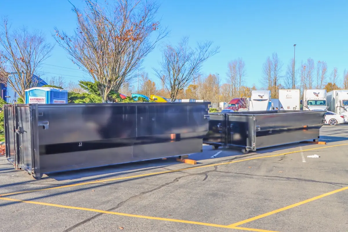 Professional dumpster rental service with roll-off container on residential driveway in El Monte